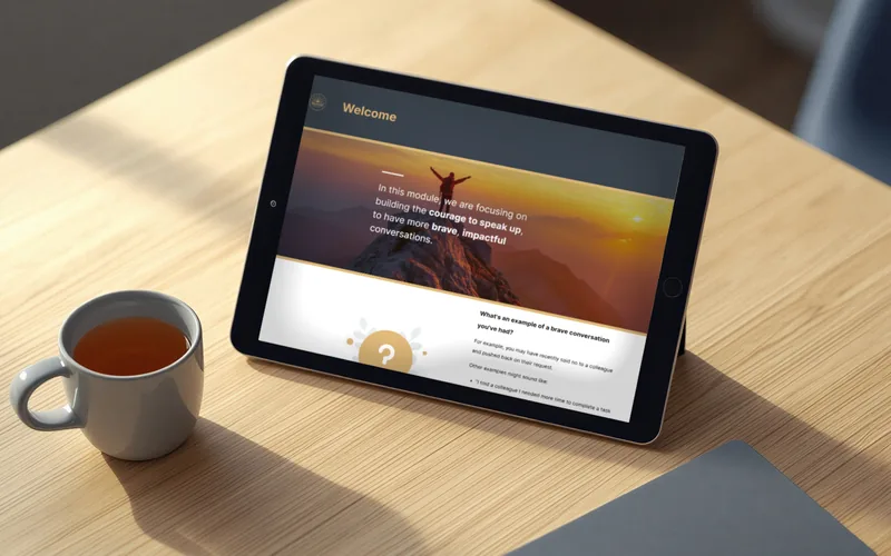 A tablet on a desk showing the welcome page of the Courage to Speak Up module